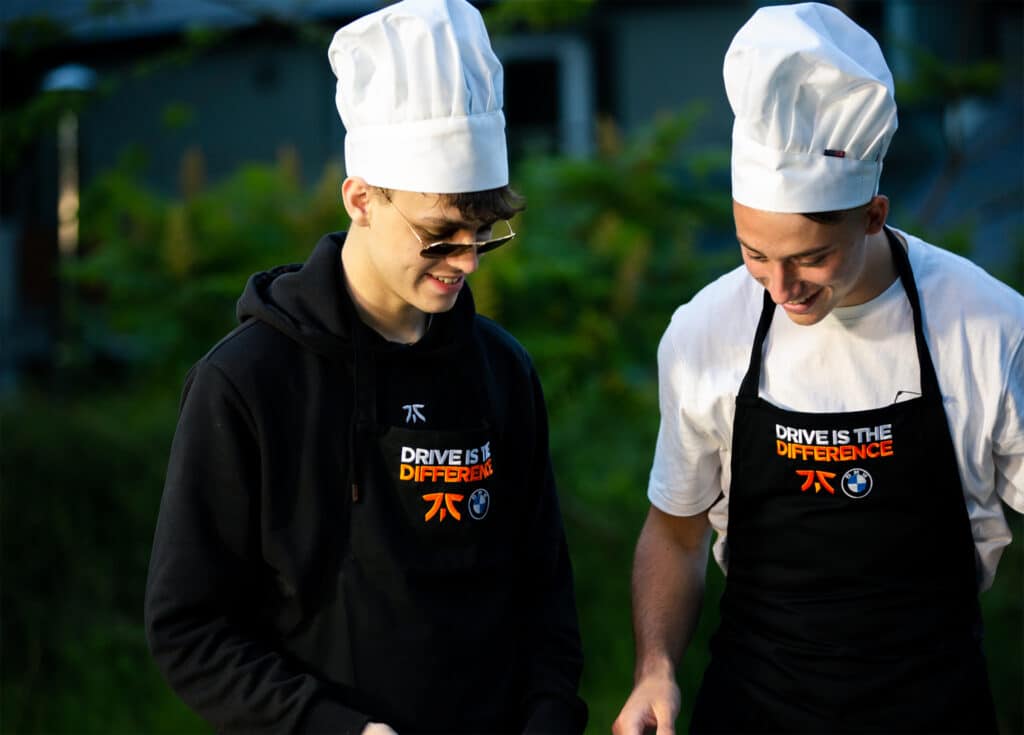 Two young men cook over a fire