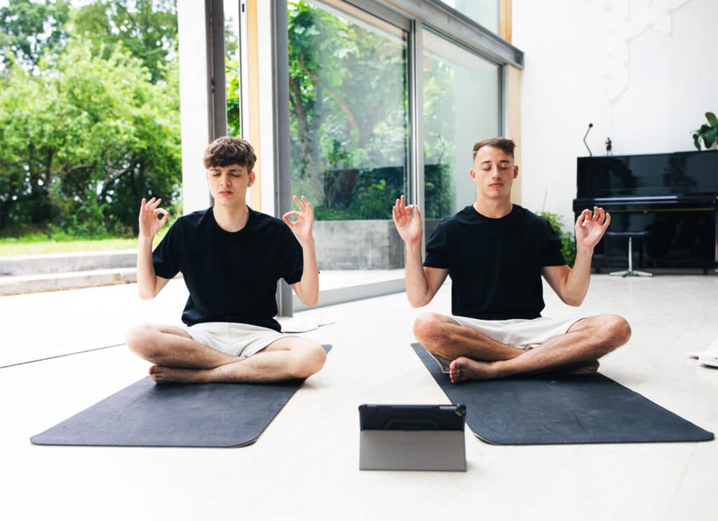 Two young men practicing yoga