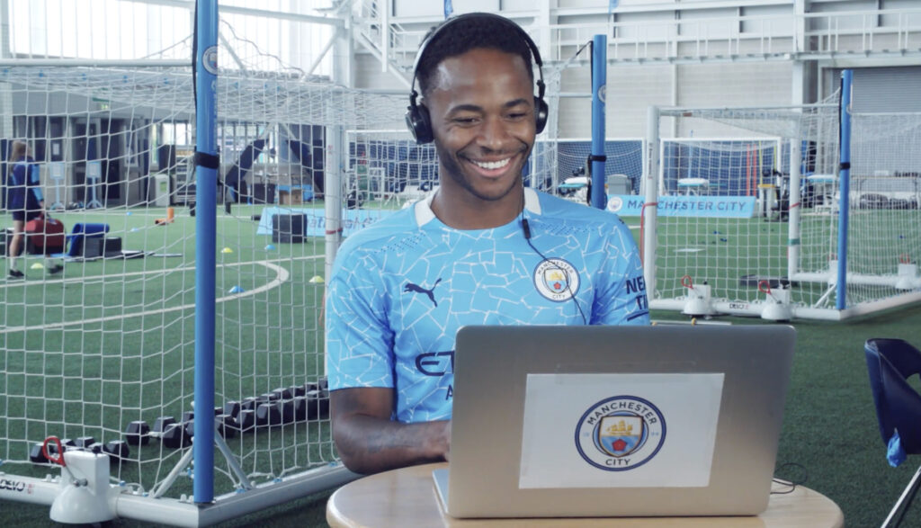 Raheem Sterling smiles as he watched the video