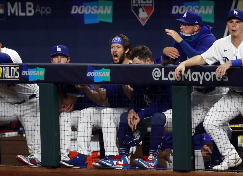 Baseball players cheer their team on